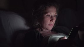 Cinematic Woman On Mobile Phone In Bed Late At Night, Using Internet 4K.