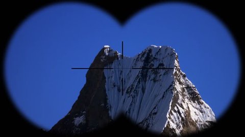 Snow Peak of Machapuchare Mountain also called Fishtail Mountain in the Himalayas in Nepal Seen through Binoculars. Hiking, Mountaineering and Trekking