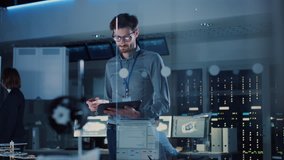 In Technology Research Facility: Chief Engineer Stands in the Middle of the Lab and Uses Tablet Computer. Team of Industrial Engineers, Developers Work on Engine Design Use Digital Whiteboard - Powered by Shutterstock - Get 15% off with code: PIKWIZARD15