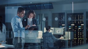 In Technology Research Facility: Female Project Manager Talks With Chief Engineer, they Consult Tablet Computer. Team of Industrial Engineers, Developers Work on Engine Design Using Computers - Powered by Shutterstock - Get 15% off with code: PIKWIZARD15