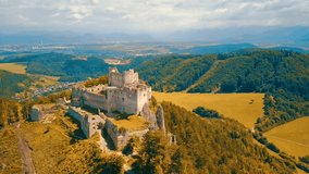 Aerial View beautiful landscape view on castle in field on the mountains background in summer sunny day with blue sky, Drone 4K Video