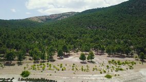 4K hd aerial drone pull back shot, revealing azure Salda Lake, mountains under forests, in Yesilova District, Burdur Province, Turkey