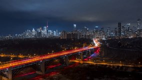 Video timelapse of Toronto downtown skyscrapers with cars driving at full speed on the Don valley Parkway creating long exposure light trails. Awesome Toronto city center skyline at night in Canada. I
