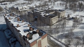 three-story brick school building, shot from a drone on a winter day