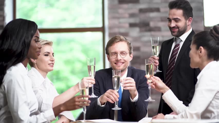 Business Team Celebrating Succesful Project With Champagne In Office. Wearing Formal Clothes. Conference Concept.