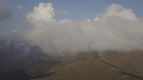 View of the mountains range in clouds from a bird's eye view