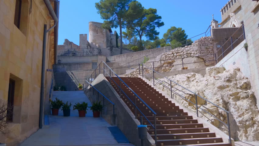 Against the blue sky inside the ancient castle in the wooded mountains of Spain attracts many tourists. Shot in motion