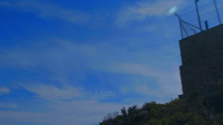 Weather radar with a rotating radiodetection antenna on top of a mountain collects weather data from whole around area against flares in the camera lens