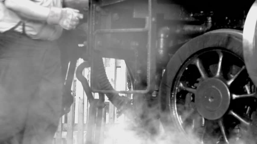 Close up of steam train wheels on track going forward with steam coming out of vents Britain UK 4K