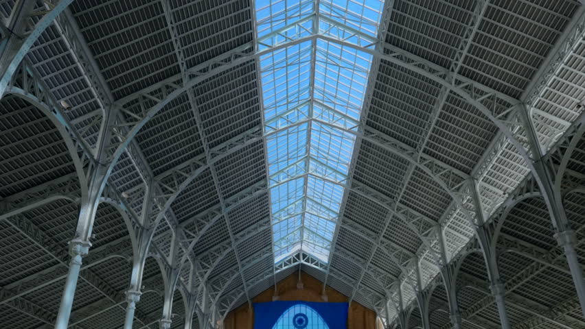 The tall building, with a window in the center of the roof, is made on the basis of metal beams, channel bars, arched profiles and is a very strong and beautiful structure - Powered by Shutterstock - Get 15% off with code: PIKWIZARD15