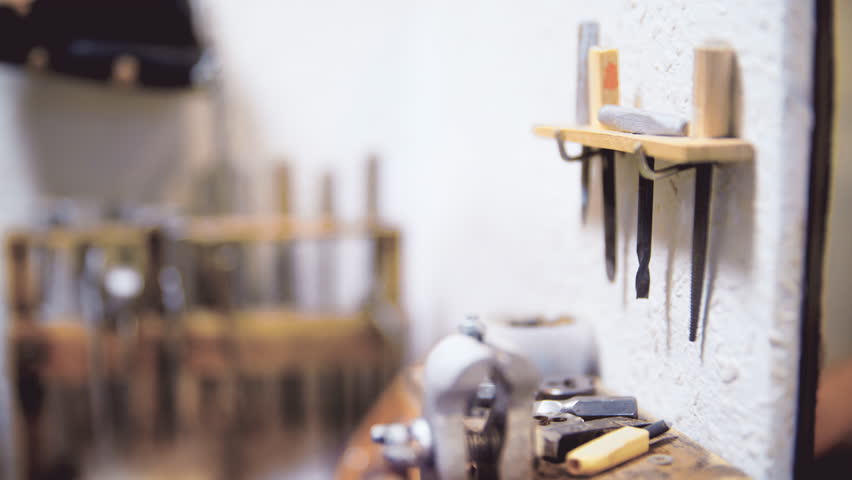 Traditional blacksmith shop panning 4K. Long shot shallow focus of a model room with blacksmith tools.