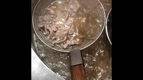 Hot soup in cooking pot with pork in Casserole pot, top view. Cooking asian style open kitchen in Asia. Street food in Asia.