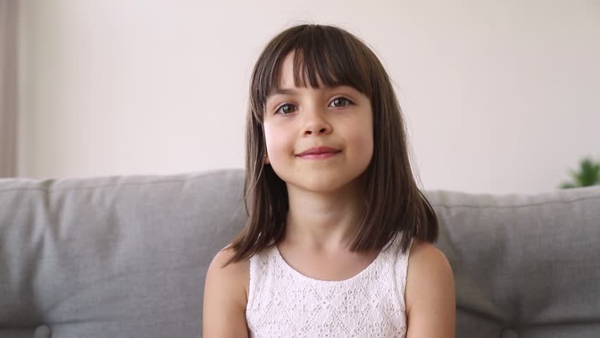 Funny little girl vlogger blogger looking at camera talking recording vlog, cute preschool pretty kid speaking to webcam making online video call having fun waving hand blowing kisses Royalty-Free Stock Footage #1025766242