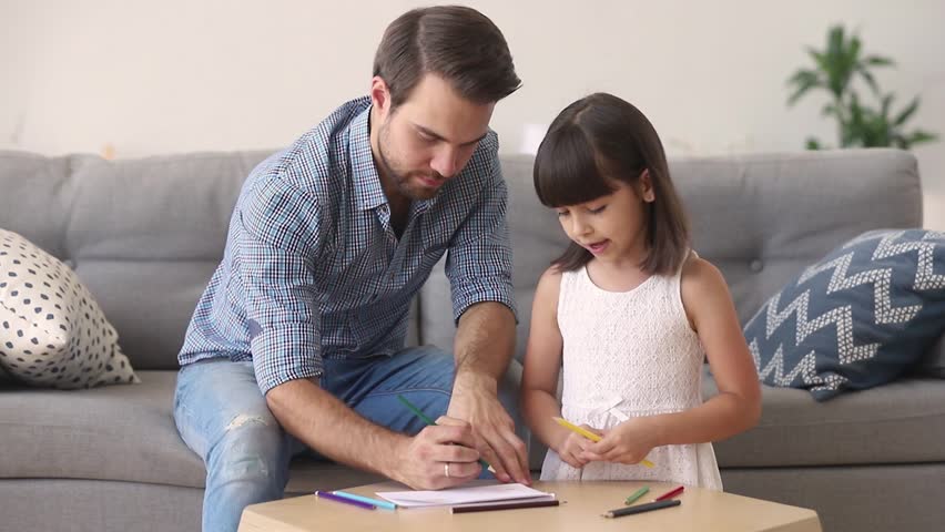 Loving dad and little daughter drawing with pencils at table coloring picture together talking at home, young father teaching helping child girl learning creative activity, parent and kid playing Royalty-Free Stock Footage #1025766263
