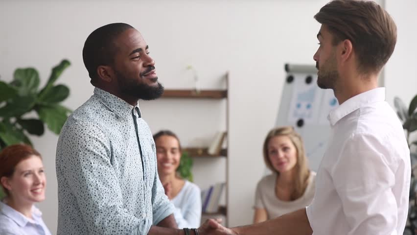 Happy proud excited african american male employee get rewarded appreciated promoted by executive boss manager motivating shaking hand of successful black office worker as gratitude respect concept Royalty-Free Stock Footage #1025766344