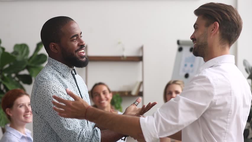 Happy proud excited african american male employee get rewarded appreciated promoted by executive boss manager motivating shaking hand of successful black office worker as gratitude respect concept | Shutterstock HD Video #1025766344