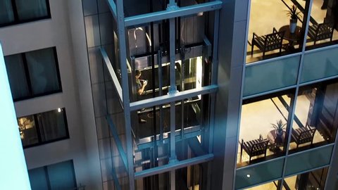 Moscow, Russia May 15, 2018: Man lifting up by the elevator with his electronic device. Man in the elevator goes up. Elevator moving upwards. Modern business center