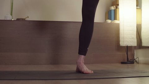 Crane shot. Close up. Young woman practicing yoga. One-leg standing balance