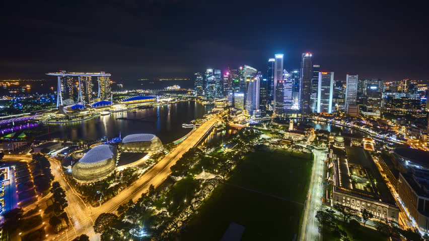 4k time lapse of night scene at Singapore city skyline, aerial view. Tilt up