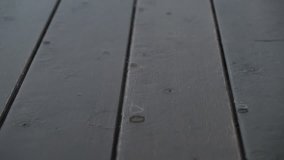 Environment and Ecology Concept. Rain Drop on the Wooden Floor. outside the House. Slow Motion Shot