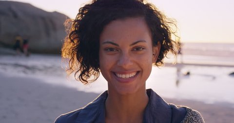 Portrait of beautiful girl smiling on beach at sunset in slow motion RED DRAGON
