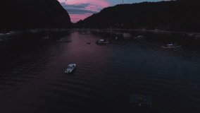 Aerial view of boats and yachts in the tropical bay on the sunset. El Nido, Palawan, Philippines. Marine tropical sunset over the sea. Travel concept.