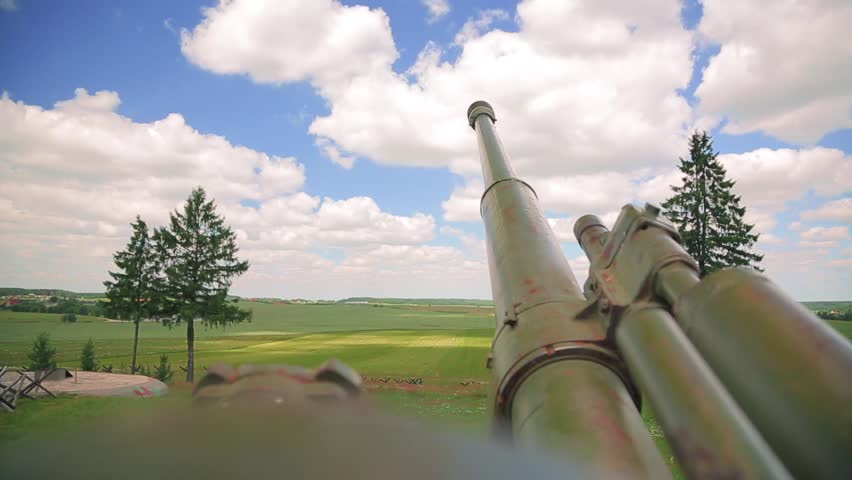 Close-up look through the artillery cannon aim. Howitzer artillery gun cannon in peaceful urban space.