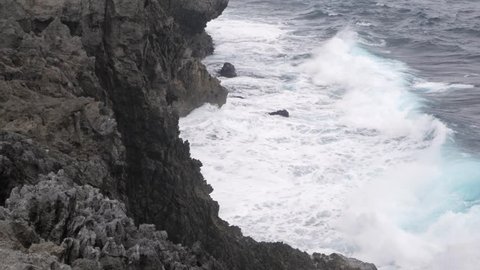 Landscape view of Cape Hedo, the northernmost point on Okinawa Island with the pacific sea in strong wind with cloudy weather, Okinawa, Japan - Tropical sea