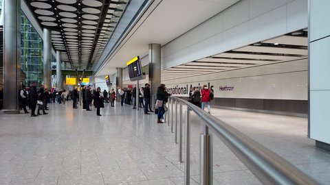 HEATHROW AIRPORT, LONDON - MARCH 16, 2019: International arrivals passengers emerge landside at Terminal 5, Heathrow International Airport in London, UK.