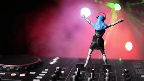 Dj club concept. Woman DJ mixing, and Scratching in a Night Club. Girl silhouette on dj's deck, strobe lights and fog on background. Creative artwork decoration with toy. Selective focus - Powered by Shutterstock - Get 15% off with code: PIKWIZARD15