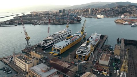 GENOA, ITALY - JANUARY 3, 2019. Aerial shot of Ente Bacini shipbuilding and ship repair facility and the cityscape