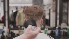 
Men's haircut in barbershop. Male hair care. Video is a vintage noise filter. An old filter.