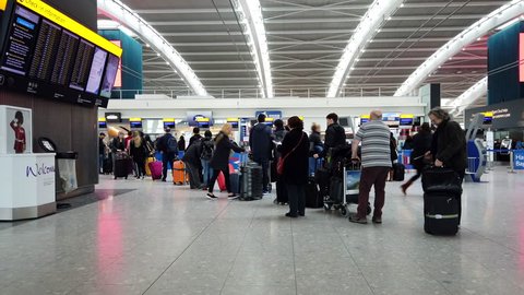 HEATHROW AIRPORT, LONDON - MARCH 16, 2019: British Airways passengers queue to check in for their flights from Terminal 5 at Heathrow International Airport in London, UK.