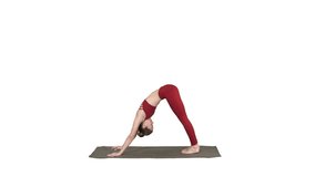 Beautiful young woman wearing red sportswear doing yoga or pilates exercise Standing in variation of Natarajasana on white background.