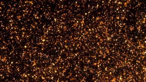 Background gold movement on black with stars. Bokeh copper sparkling particles move chaotically under water. Can be used as transitions in projects.