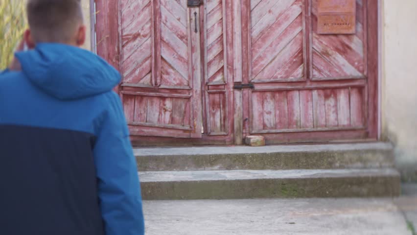 An angy teenager speaks by mobile and smashes a mobile phone