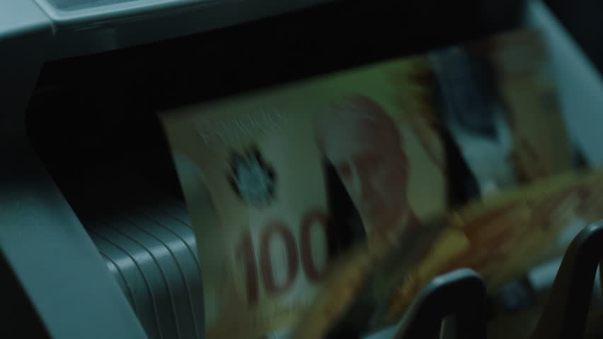 Close up of money counter counting Canadian currency. Filmed with Arri Alexa Mini