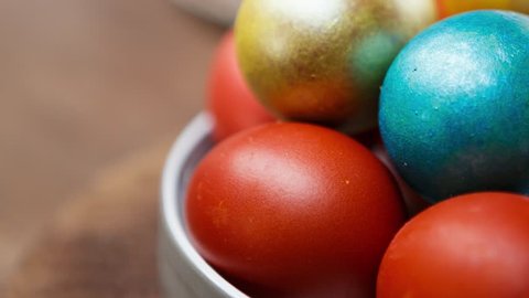 Footage of colorful boiled chicken eggs painted in vibrant colors for Easter celebration.Decorated natural food for orthodox christian holiday in spring