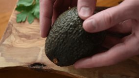 Closeup view of avocado in hands. Avocado open. Ripe tasty avocado, vegan healthy food