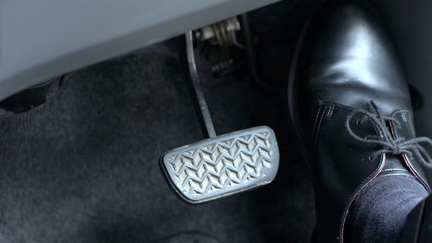 Man driving with pedals of a car