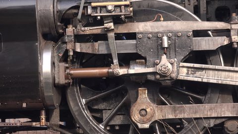 Steam train close up of wheels traditional shot with smoke Yorkshire UK England 4K