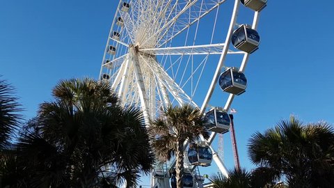 Myrtle Beach, South Carolina, United States - October 29, 2018: Ferris wheel near the beach during a sunny sunset.