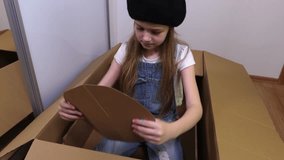 Little Girl playing with cardboard box