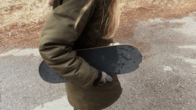 Little Girl with skateboard at outdoor
