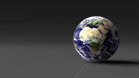 Animation of rotating planet Earth placed on grey desk. Seamless video of Earth with day and night phase. Globe with ground, oceans and clouds. Elements of video furnished by NASA