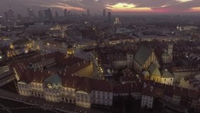 Aerial view of the royal palace and rooftops old buildings. Warsaw / Poland, Old Town at night. Taken from the drone in RAW Format. 4K.
