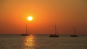  Yachts and sailing boats on the background of a beautiful sunset.  Beautiful sunset on the beach.  4k footage.   Time lapse footage. Thailand. Phuket. Andaman sea. 