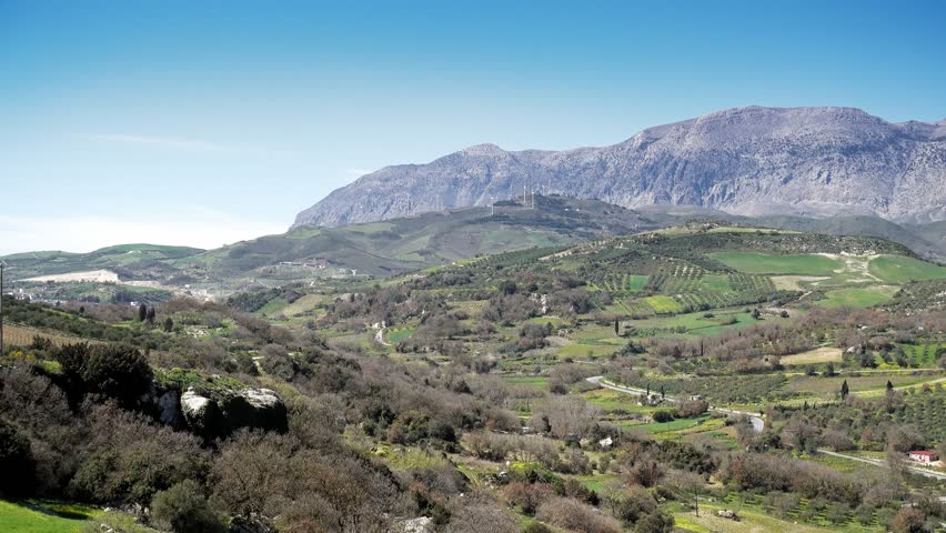 Agricultural field and mountain against sky, Crete, Greece