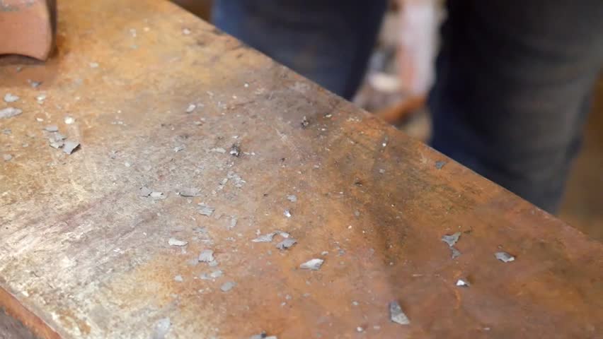 Close Up of Tapering Delicate Metal Bar with Hammering at the Anvil