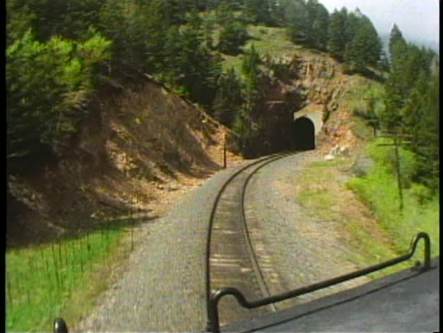 ROCKY MOUNTAINS, COLORADO, 1994, POV from locomotive, enters a tunnel, emerges